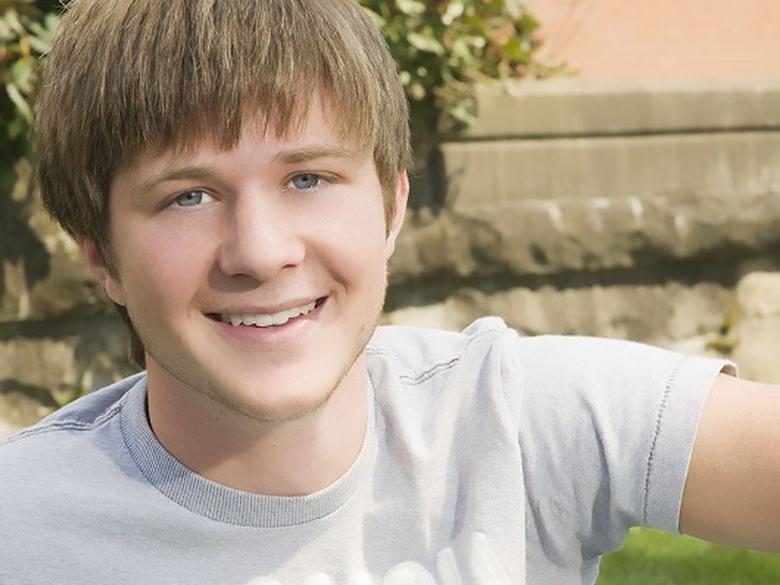 Student in gray shirt smiling